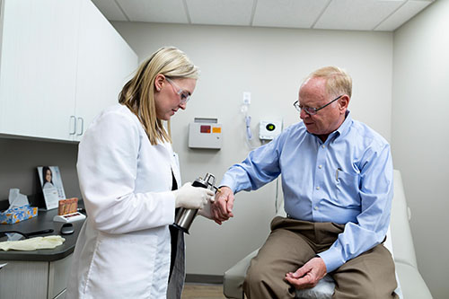 Mod Dermatology Dermatologist treating an elderly patient